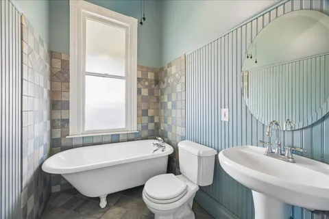 a front view of a house with a garden and plants