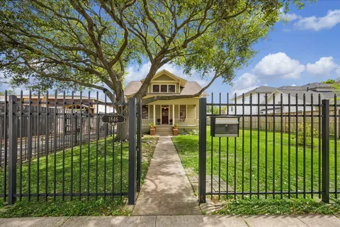 a front view of a house with a garden and outdoor seating
