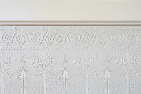 a view of a livingroom with wooden floor a ceiling fan and windows