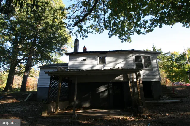 a house view with a tree in front of it