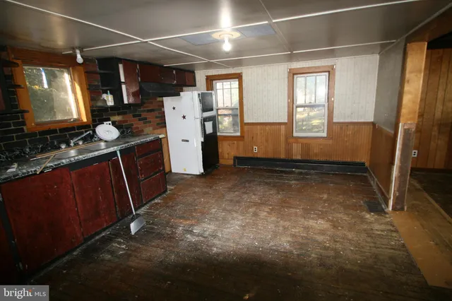 a kitchen with refrigerator and window