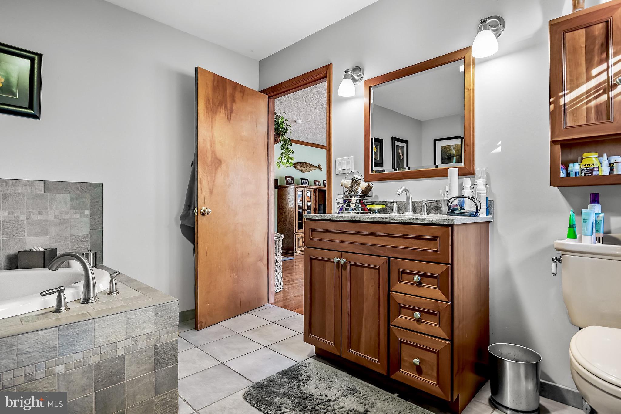 26 Tuckerton Road Shamong, NJ 08088 - Photo 20 of 44 a bathroom with a toilet a sink and a mirror