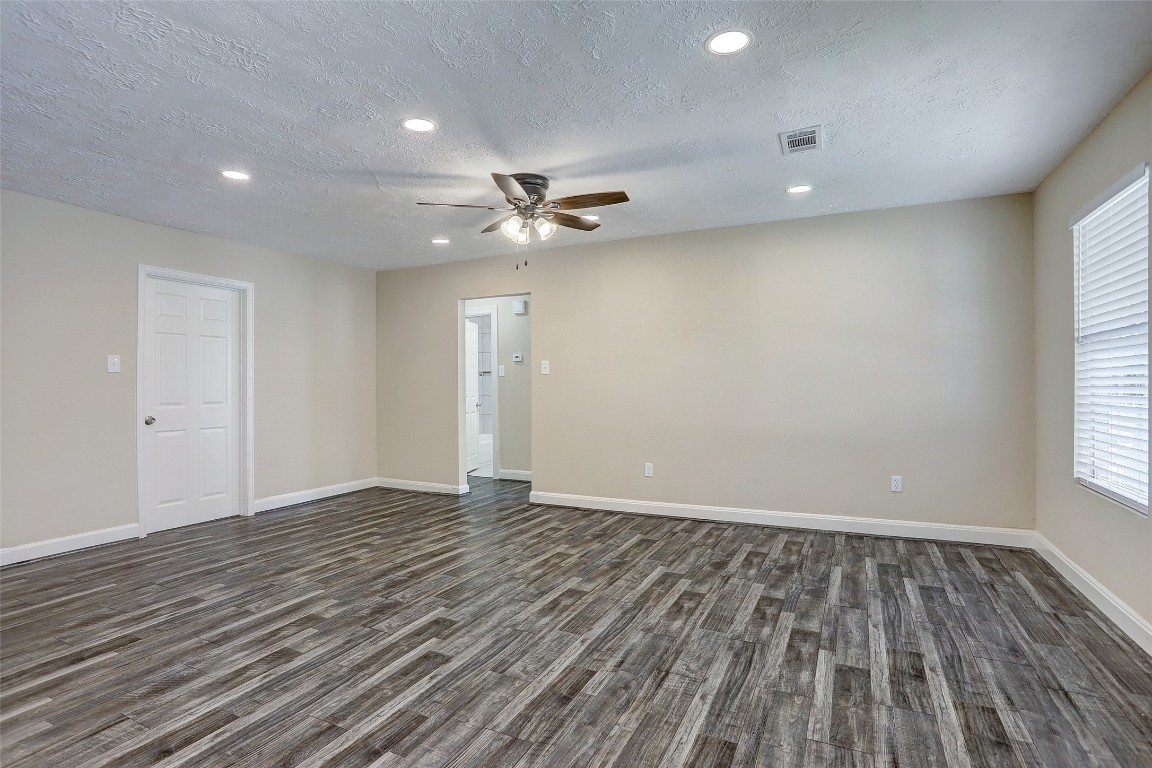 515 Main Street Pasadena, TX 77506 - Photo 2 of 10 an empty room with wooden floor and windows