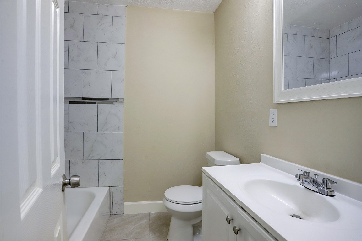 515 Main Street Pasadena, TX 77506 - Photo 6 of 10 a bathroom with a sink a toilet and shower