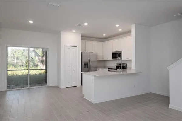 a kitchen with stainless steel appliances a refrigerator and a stove top oven