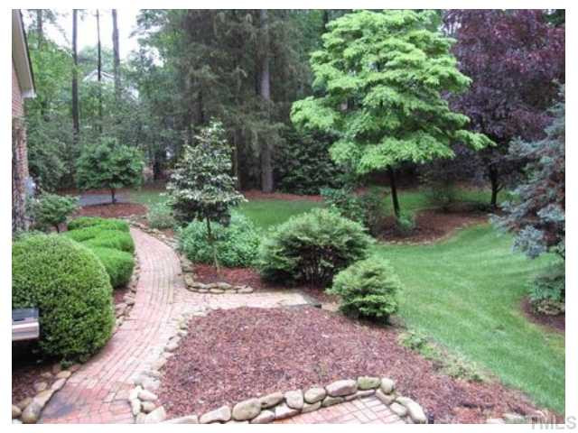 208 Claflin Court Raleigh, NC 27614 - Photo 15 of 22 Beautifully landscaped yard with water feature and two brick patios. Yard