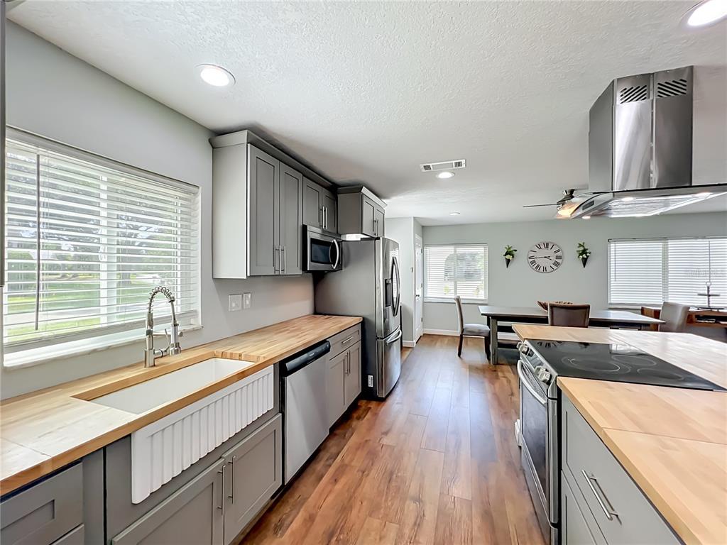 153 Variety Tree Circle Altamonte Springs, FL 32714 - Photo 11 of 44 a large kitchen with stainless steel appliances granite countertop a lot of counter space and wooden floors