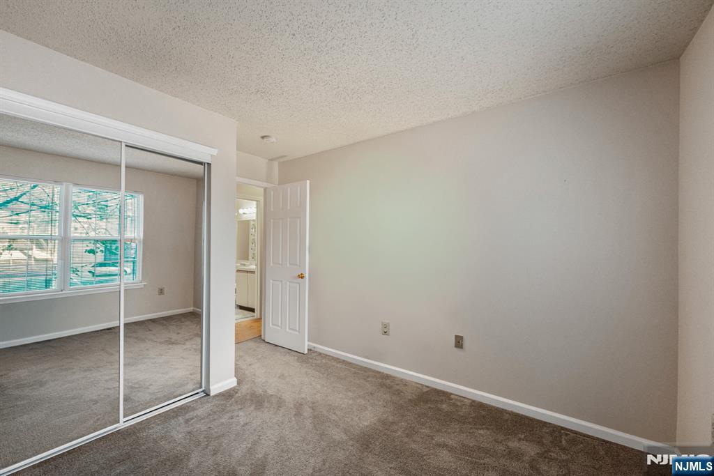 159 Market Street, Unit 1411 Newark, NJ 07102 - Photo 12 of 19 an empty room with sliding glass door