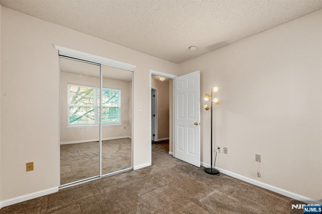 159 Market Street, Unit 1411 Newark, NJ 07102 - Photo 15 of 19 an empty room with sliding glass door