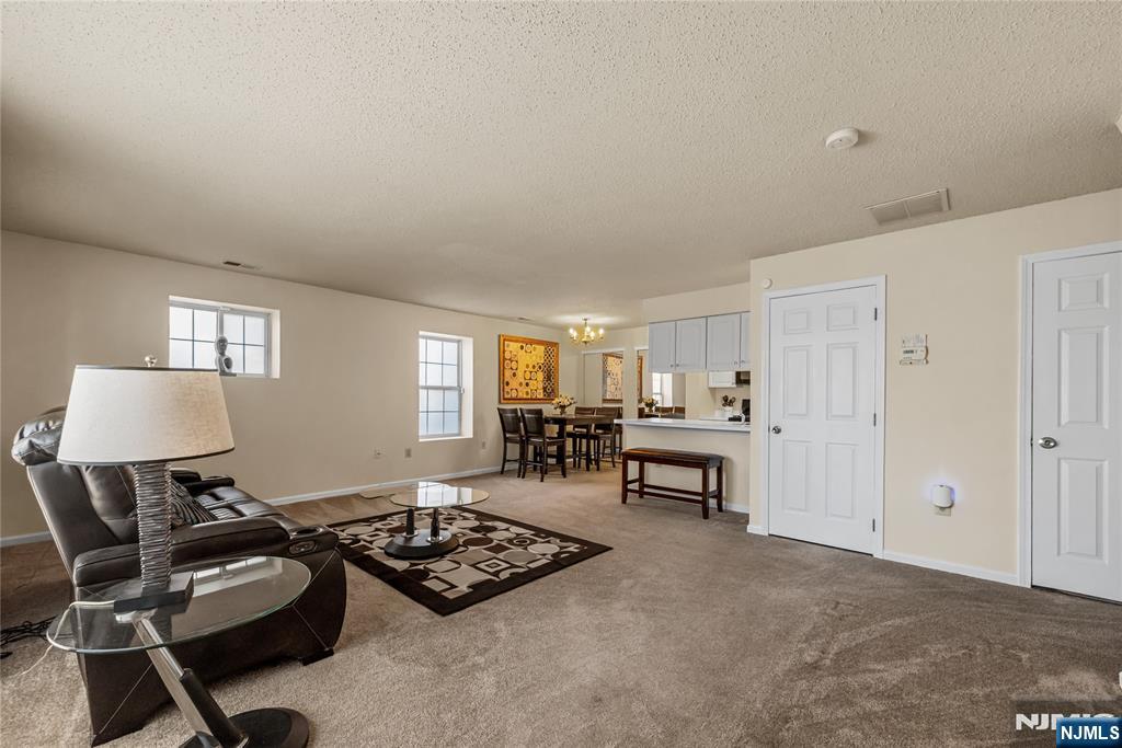 159 Market Street, Unit 1411 Newark, NJ 07102 - Photo 2 of 19 a living room with furniture and a window
