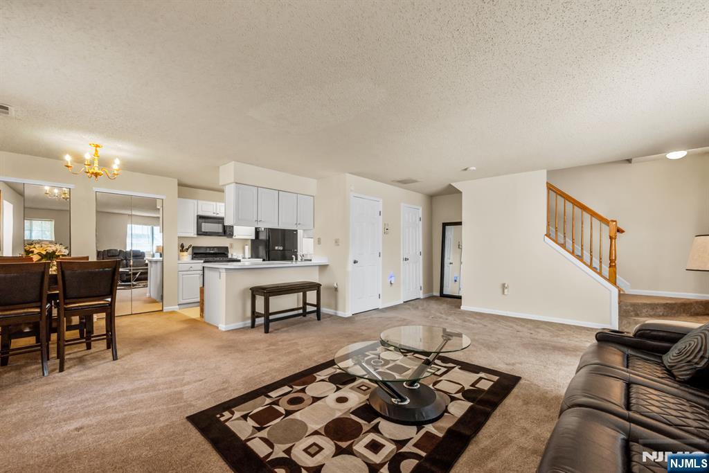 159 Market Street, Unit 1411 Newark, NJ 07102 - Photo 3 of 19 a living room with furniture and a rug