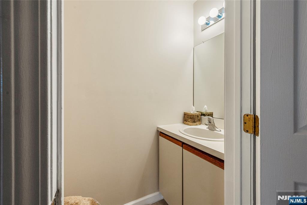 159 Market Street, Unit 1411 Newark, NJ 07102 - Photo 8 of 19 a bathroom with a sink and a mirror