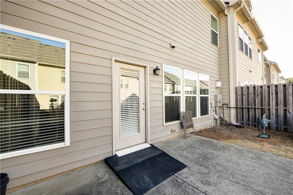 1226 Fischer Trace Cumming, GA 30041 - Photo 23 of 24 a view of a patio with table and chairs and wooden fence