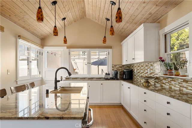 a large white kitchen with a large window