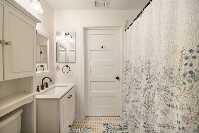 a bedroom with a bed and a mirror