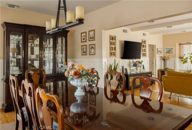a living room with furniture a flat screen tv and a floor to ceiling window