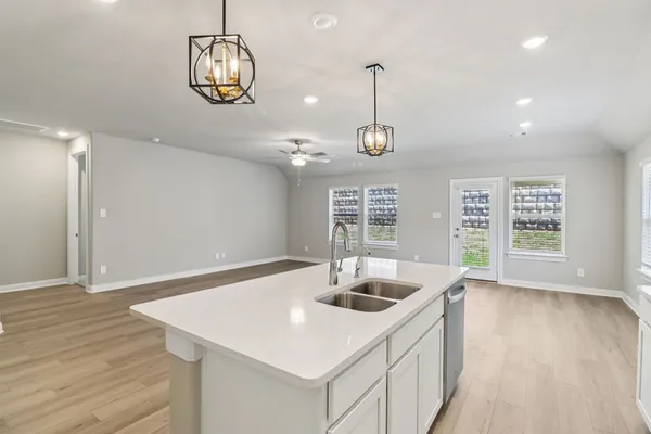 a kitchen with stainless steel appliances granite countertop a sink a oven and wooden floor