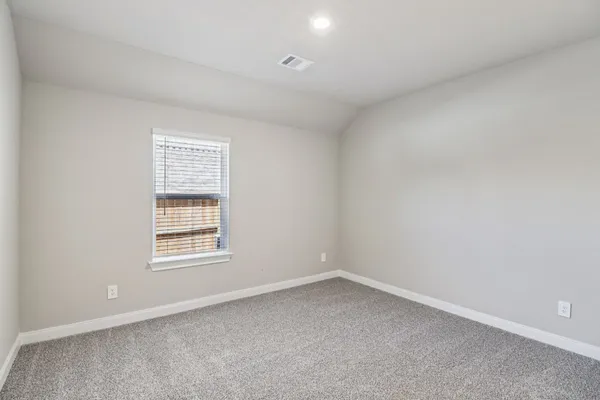 an empty room with closet area