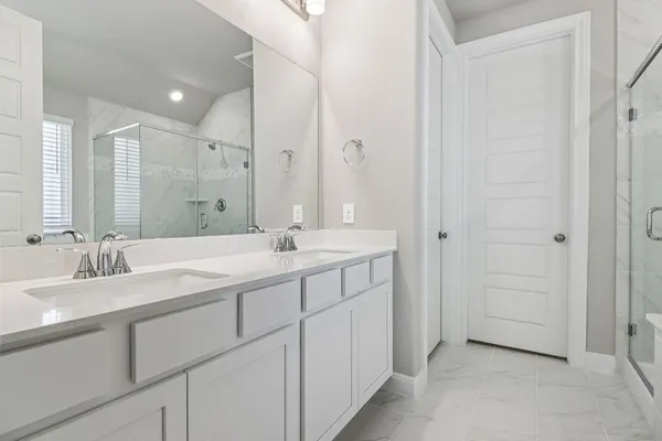 a bathroom with a tub a sink and a shower