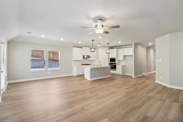 a view of kitchen with cabinets and wooden floor