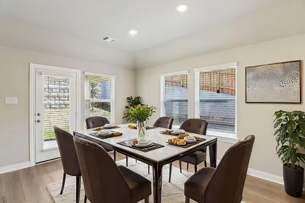 a view of a dining room with furniture window and wooden floor