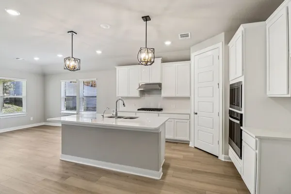 a large kitchen with stainless steel appliances kitchen island a large island in the center