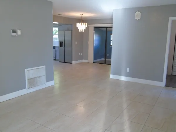 an empty room with mirror and entrance
