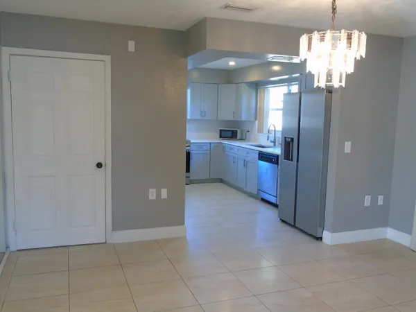 a view of a kitchen with a refrigerator a sink and dishwasher