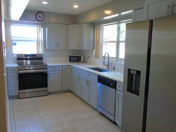 a kitchen with a sink stove and refrigerator