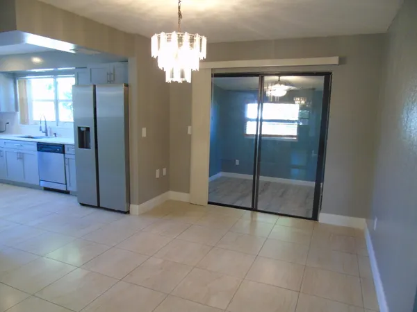 a view of a hallway with granite countertop a chandelier