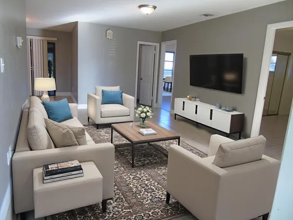 a living room with furniture and a flat screen tv