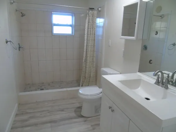 a bathroom with a sink toilet and shower