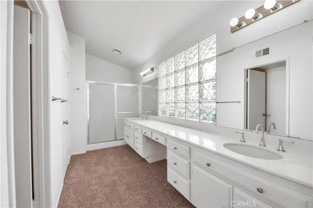 a spacious bathroom with a double vanity sink mirror and double