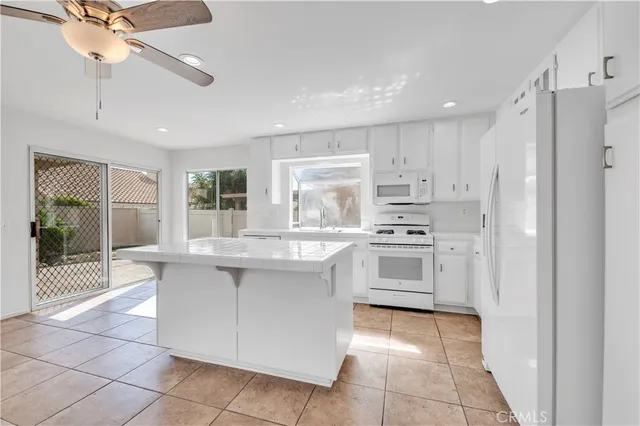 a kitchen with stainless steel appliances granite countertop a stove and a refrigerator