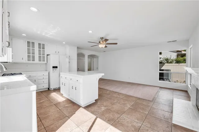 a large white kitchen with a white countertops and cabinets
