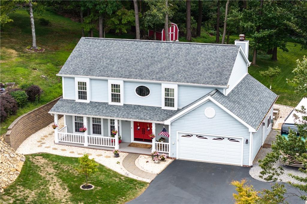 a aerial view of a house with swimming pool and a yard