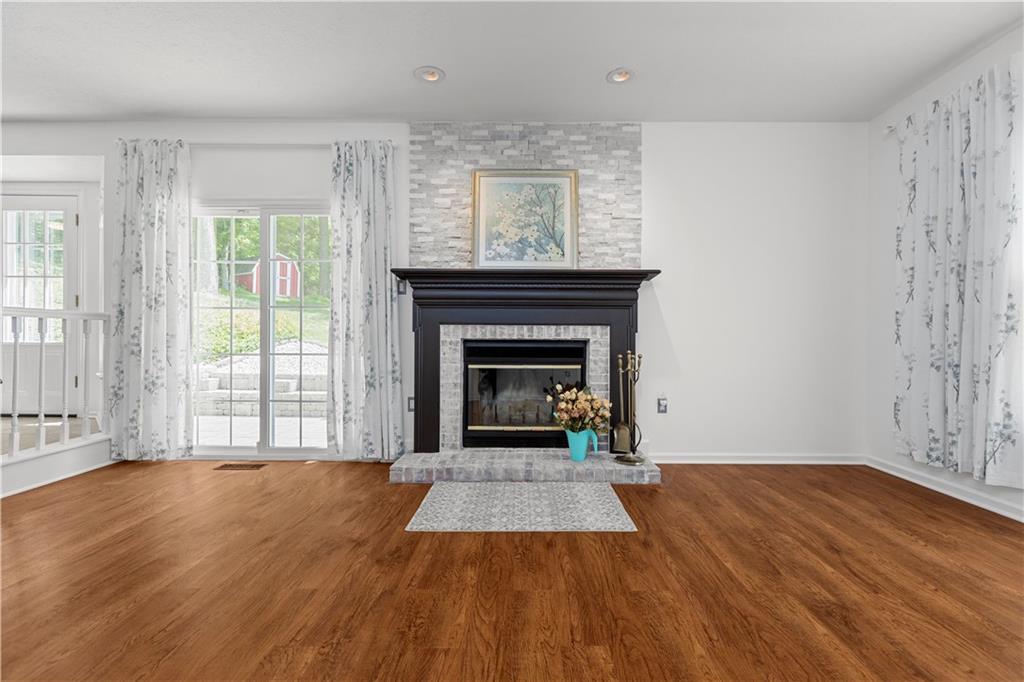 1626 Forest Ridge Drive Pittsburgh, PA 15237 - Photo 18 of 34 a view of an empty room with wooden floor fireplace and a window