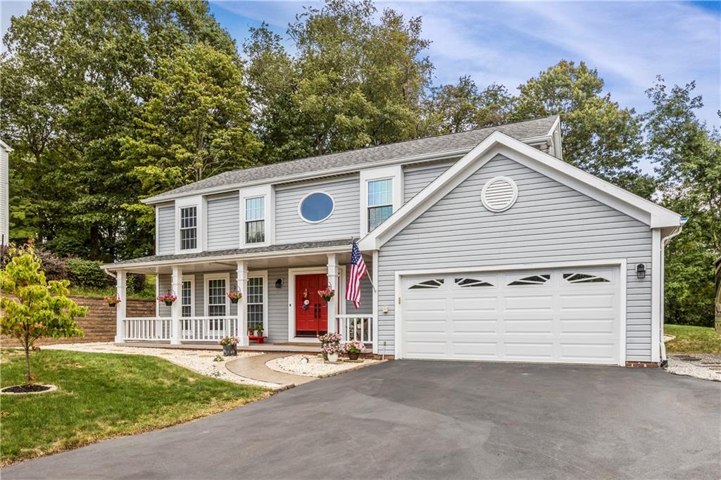 1626 Forest Ridge Drive Pittsburgh, PA 15237 - Photo 31 of 34 a view of a white house with large windows and a small yard