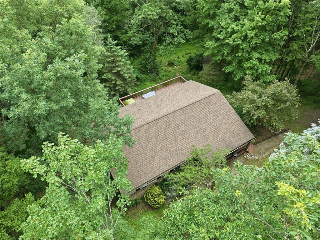 520 Highland Hill Road Jim Thorpe, PA 18235 - Photo 72 of 83 Nestled amidst verdant trees, this secluded home features a broad roof and an upper deck.