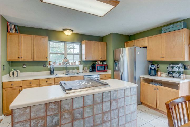 115 East Piney Road Dickson, TN 37055 - Photo 14 of 38 a kitchen with stainless steel appliances a refrigerator sink and cabinets