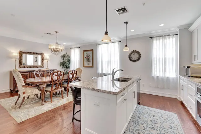 a large kitchen with a table and chairs