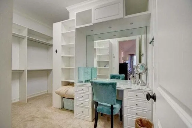 a room with a couch and a view of kitchen