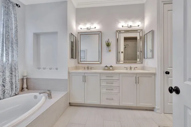 a bathroom with a bathtub sink and mirror