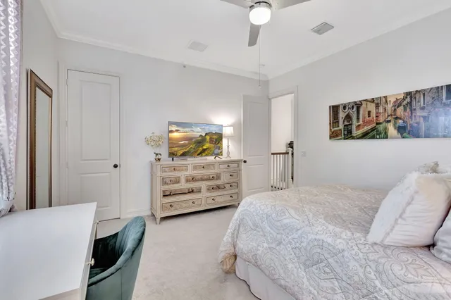 a bedroom with a bed and a tv on the dresser