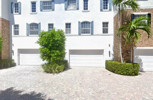 a couple of potted plants in front of a building