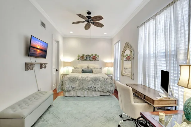 a bedroom with furniture and a flat screen tv