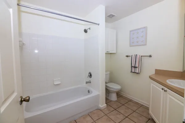 a bathroom with a bath tub a toilet and a sink