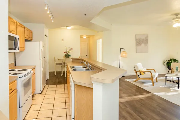 a kitchen with a sink a stove and a refrigerator