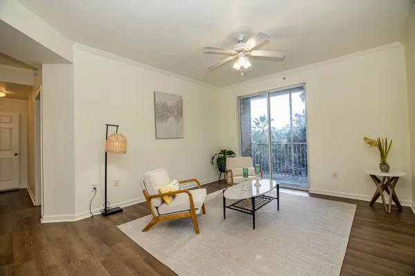 a living room with furniture and wooden floor