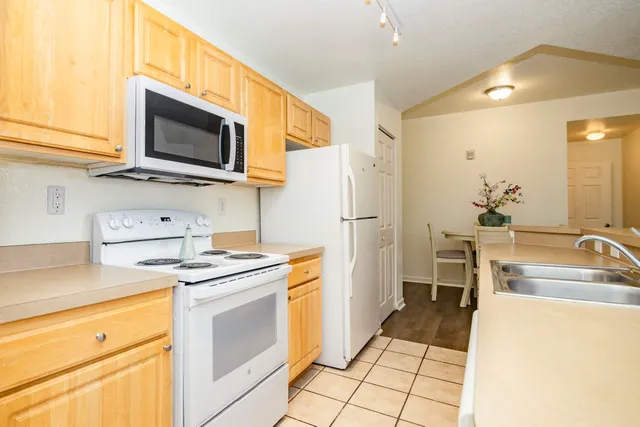 a kitchen with stainless steel appliances a stove microwave and a sink